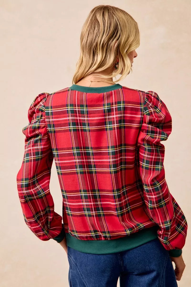 Red plaid top with exaggerated shoulders and green hem, back view