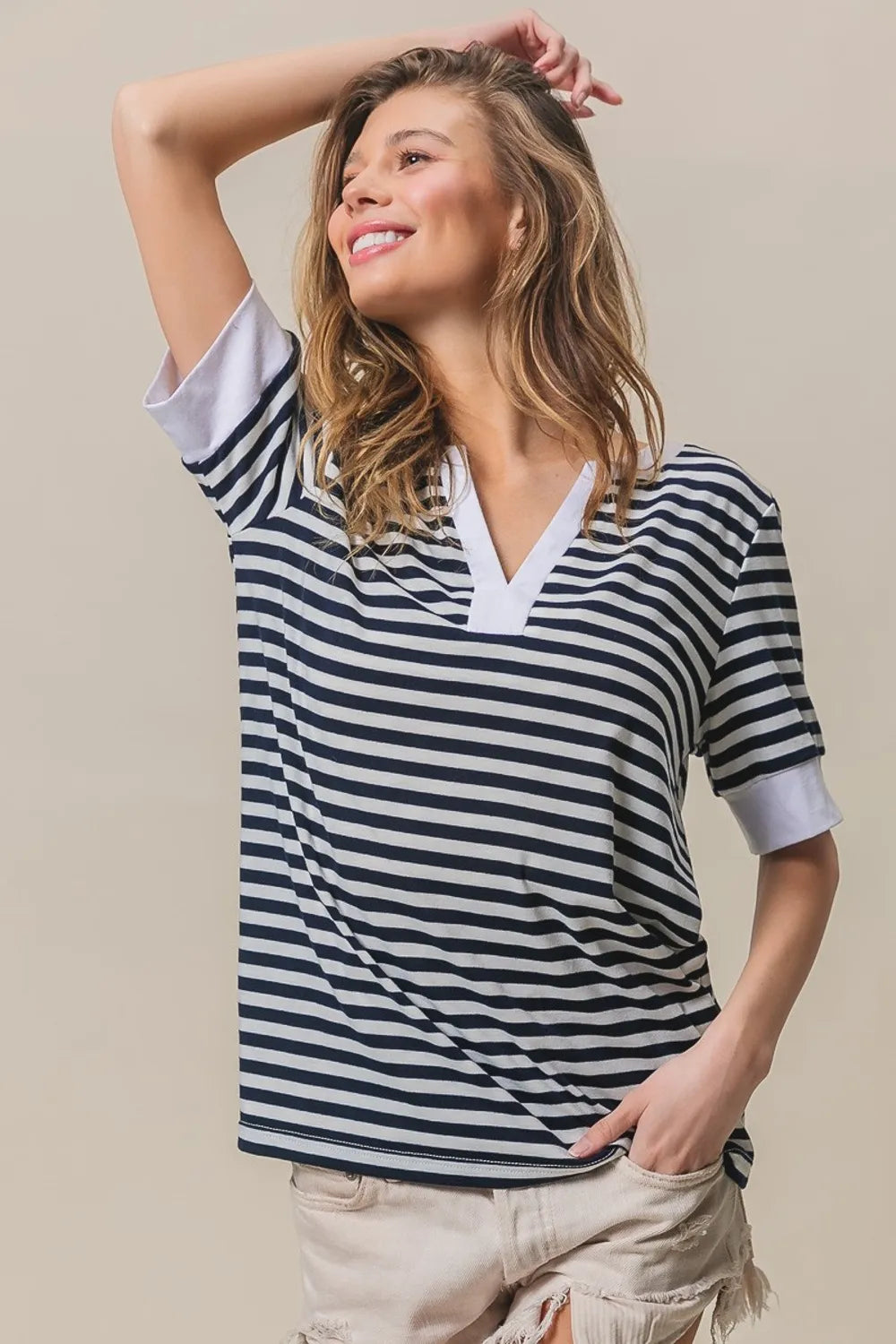 Contrast striped notched knit top, navy and ivory V-neck, short sleeves with contrast trim.