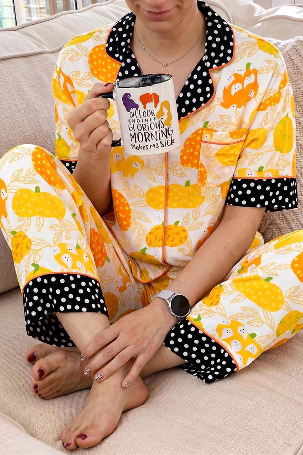 Short-sleeve pumpkin print pajama set with polka-dot trim; close-up of pocket and buttons