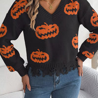 Black knit pumpkin sweater with orange jack-o’-lanterns, V-neck, and distressed hem fringe