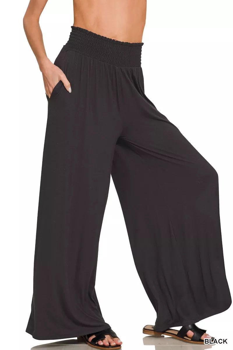 Black smocked-waist wide-leg palazzo pants with flowing relaxed drape