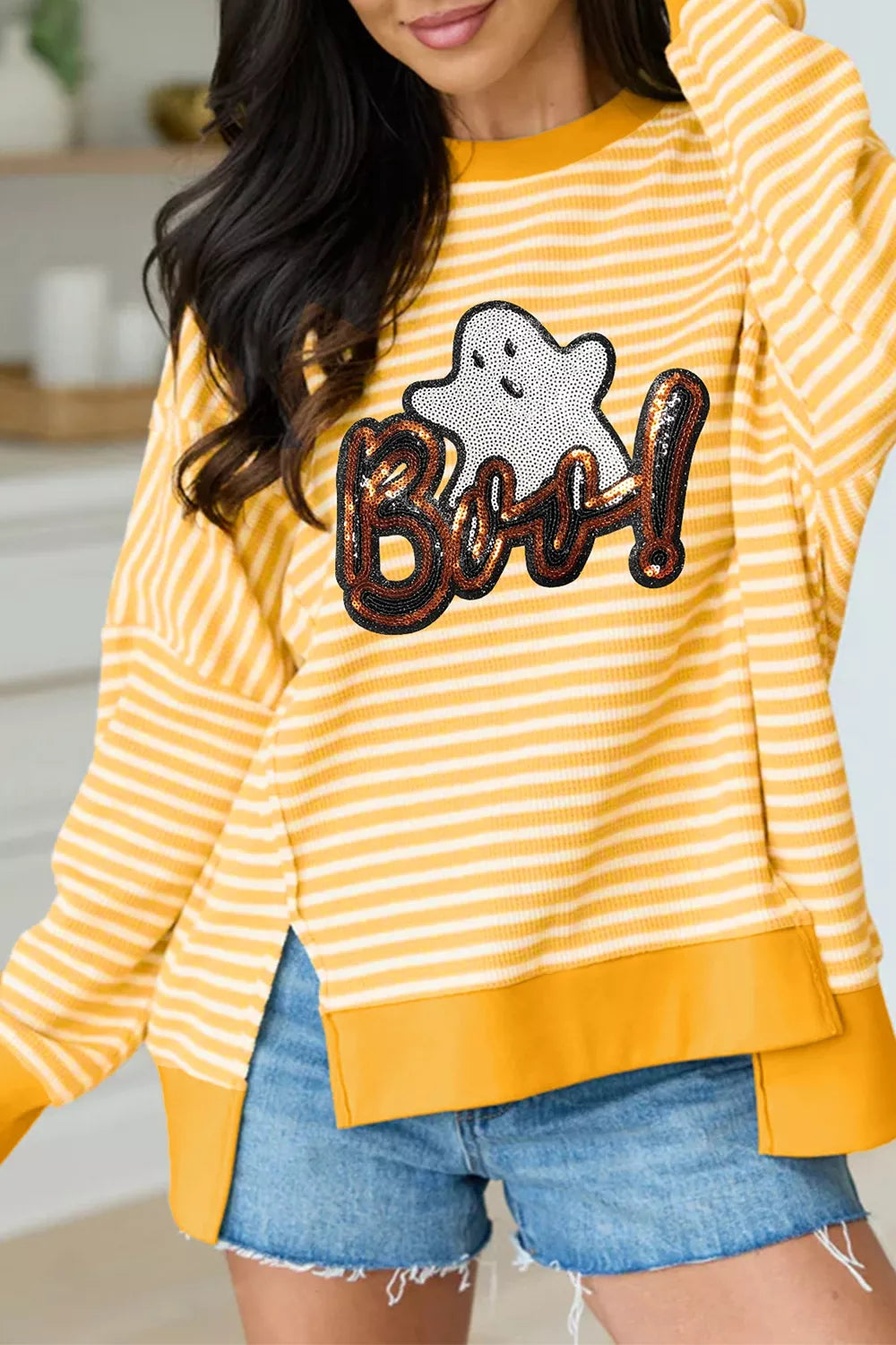 Gold and white striped long-sleeve top with sequin ghost “Boo!” graphic, split hem