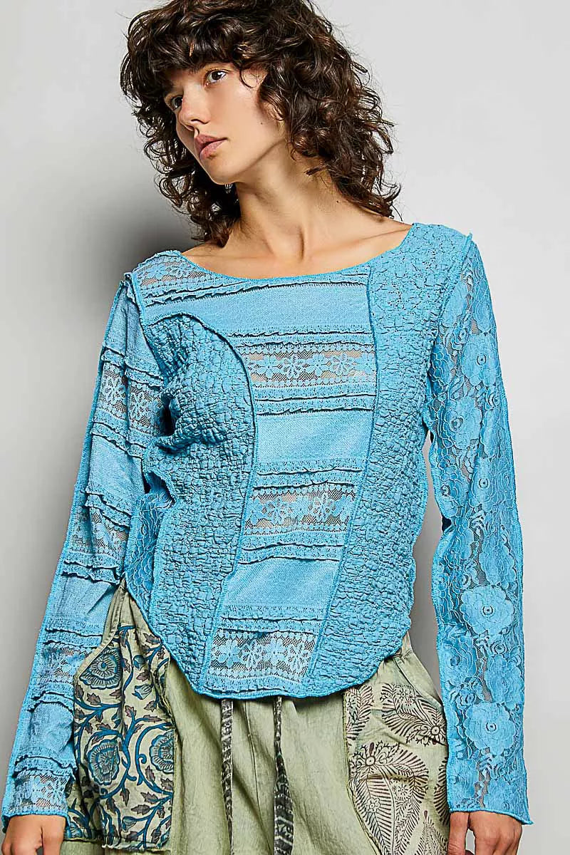 Teal blue lace patchwork long-sleeve top with exposed seams and round neckline