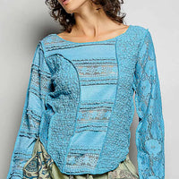 Teal blue lace patchwork long-sleeve top with exposed seams and round neckline
