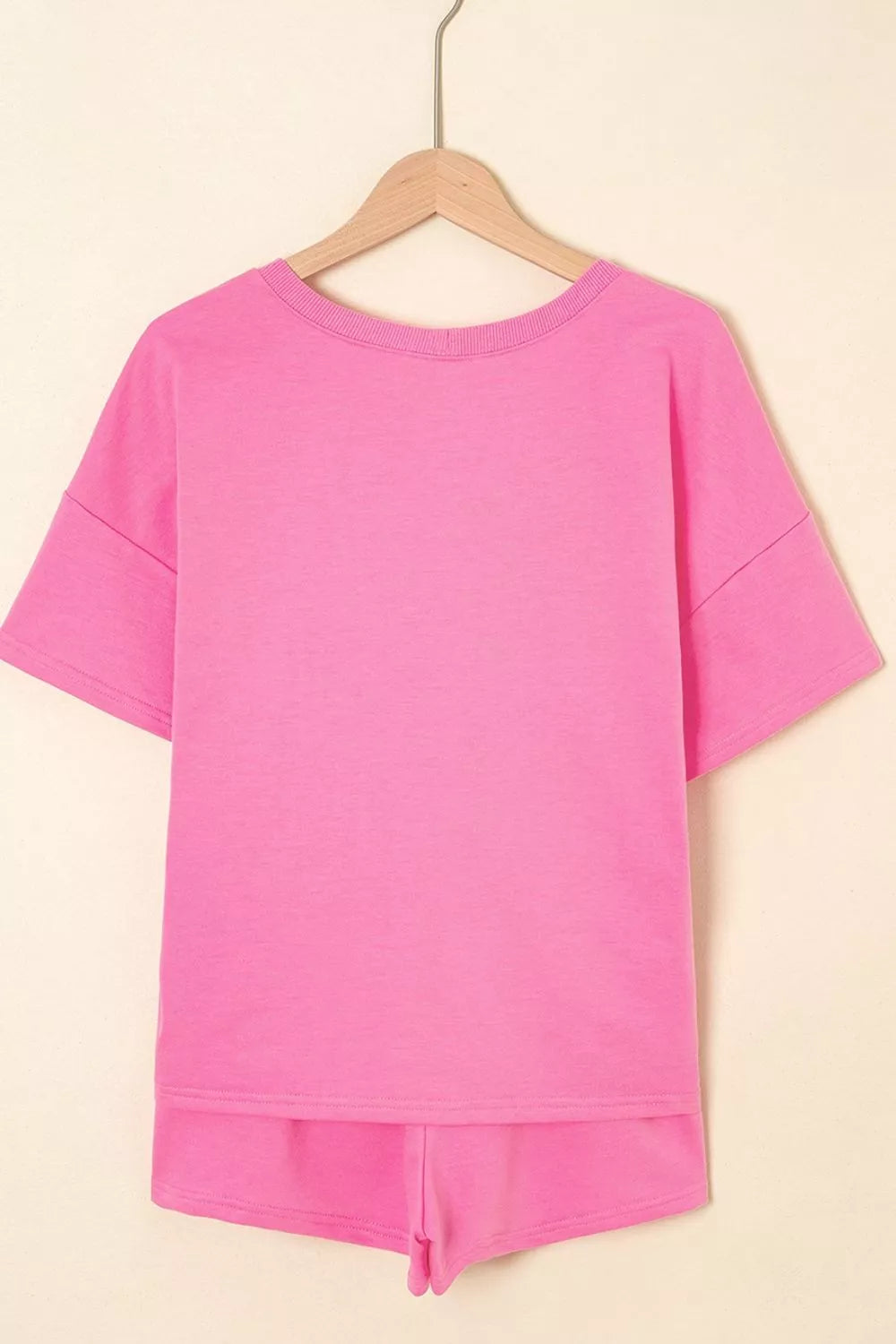 Fuchsia pink plain back short-sleeve tee and drawstring shorts set on hanger