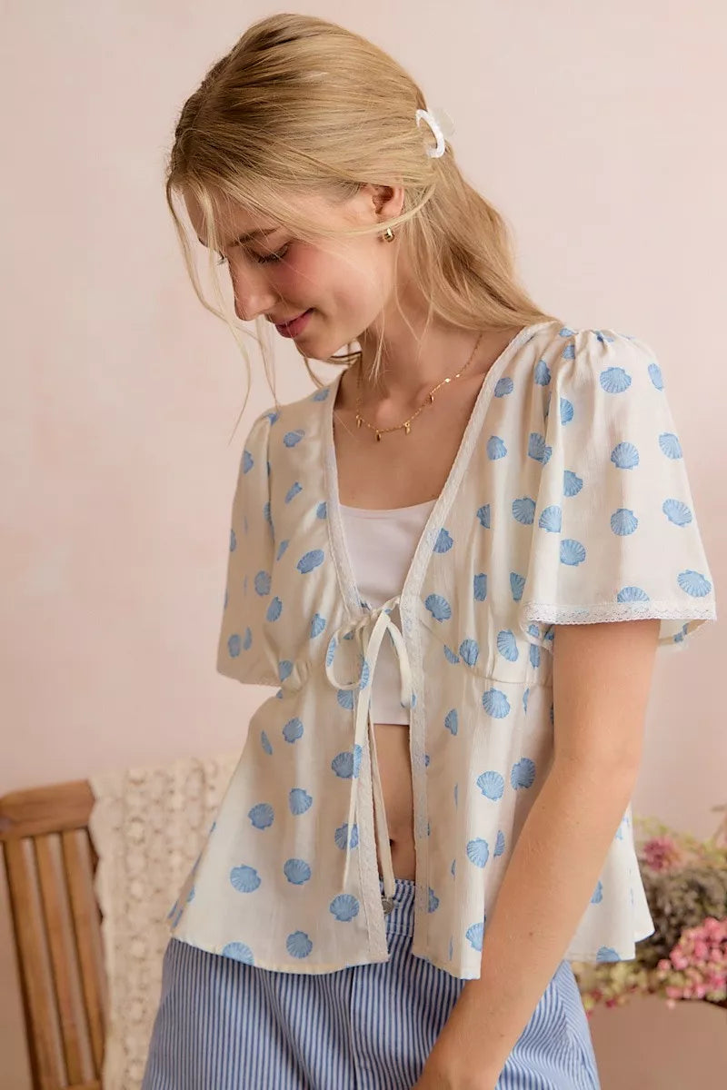Light ivory shell-print blouse with tie-front and short flutter sleeves