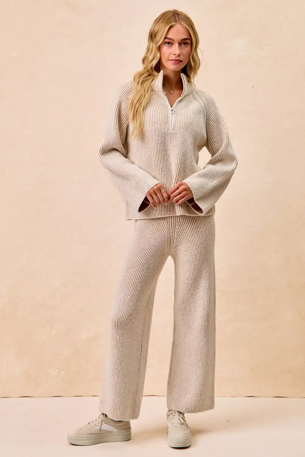 Taupe ribbed knit top with quarter-zip stand collar and long sleeves