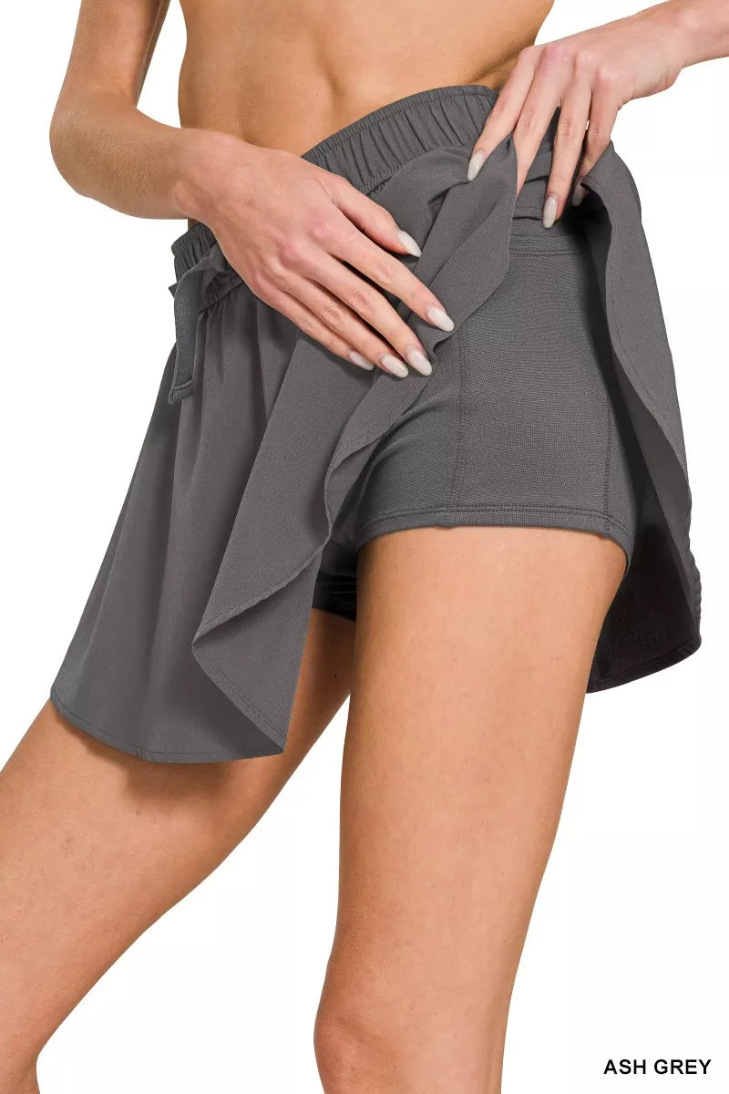 Ash grey woven active skort detail: elastic waist, tie bow, layered skirt
