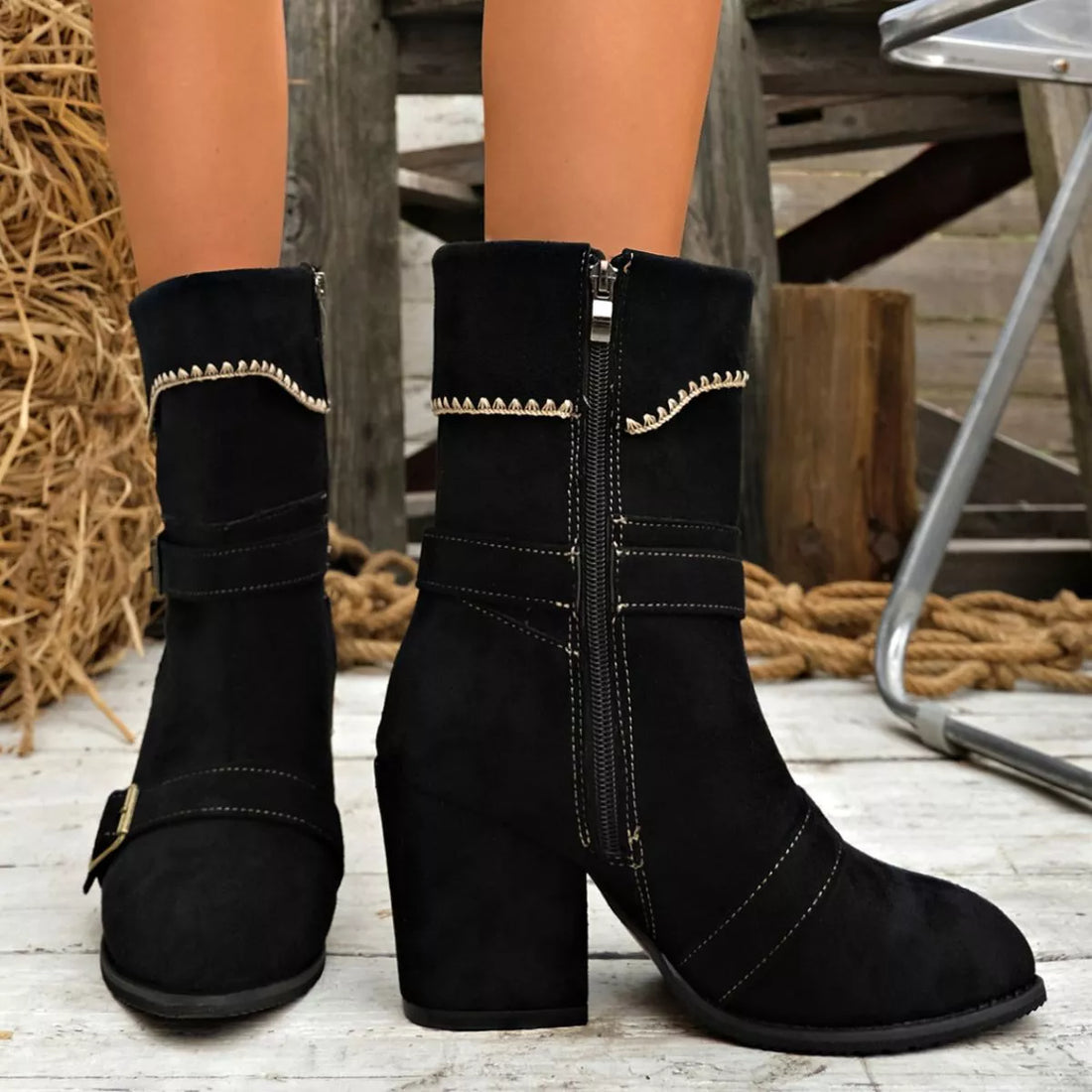 Black suede point-toe ankle boots with block heel and side zipper, buckle strap.