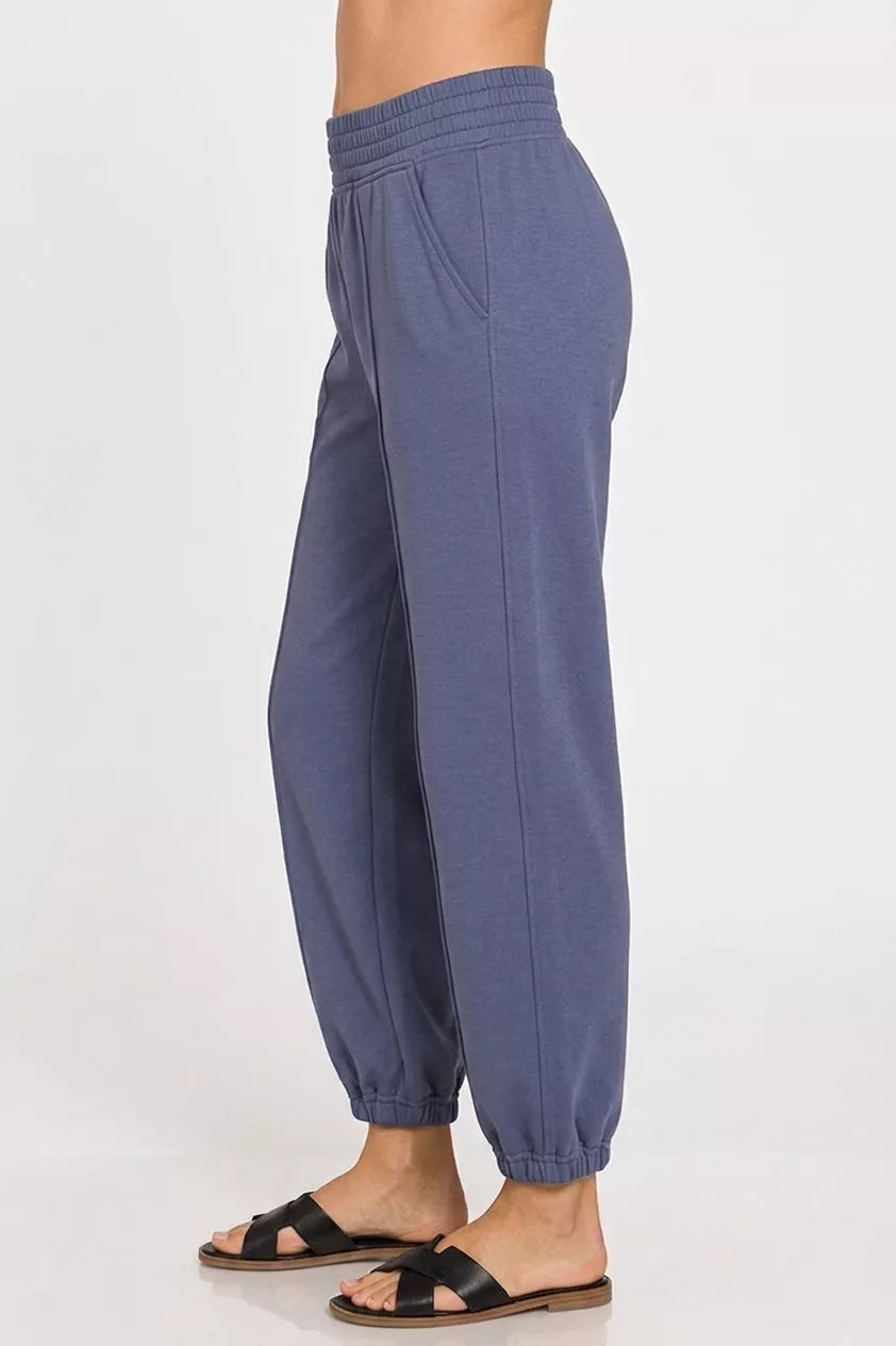 Indigo-blue scuba joggers, elastic waistband, tapered ankle cuffs, side pockets