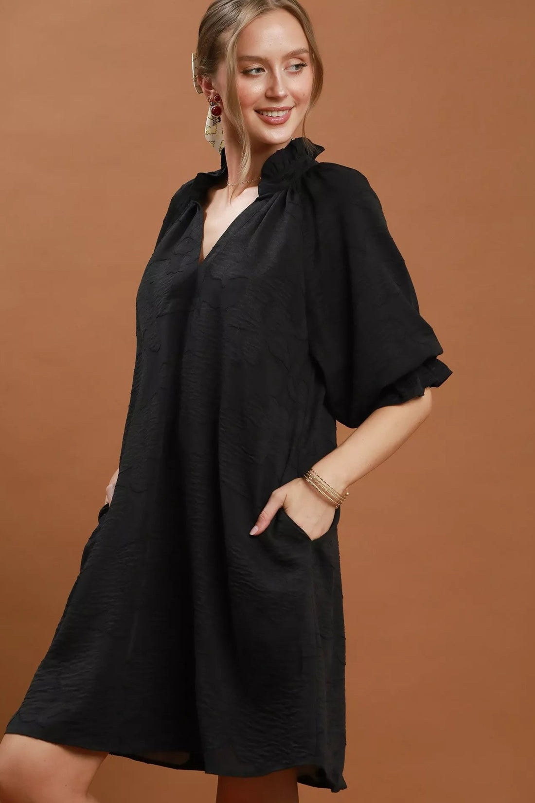 Black V-neck textured dress with loose fit and draped flutter sleeves