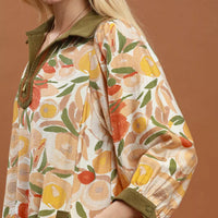 Floral shift mini dress close-up with olive contrast trim and three-quarter puff sleeve