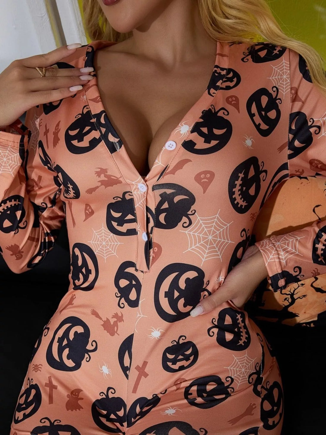 Dusty pink button-front lounge romper, long sleeves, jack-o-lantern and spiderweb pattern