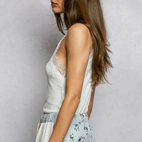 Women's off-white lace-trim V-neck cami with spaghetti straps, back/side view