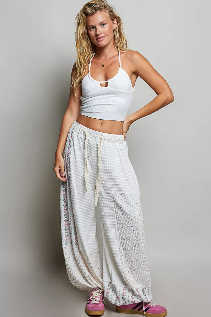 Ivory patchwork knit wide-leg pants with elastic waistband and allover speckled accents