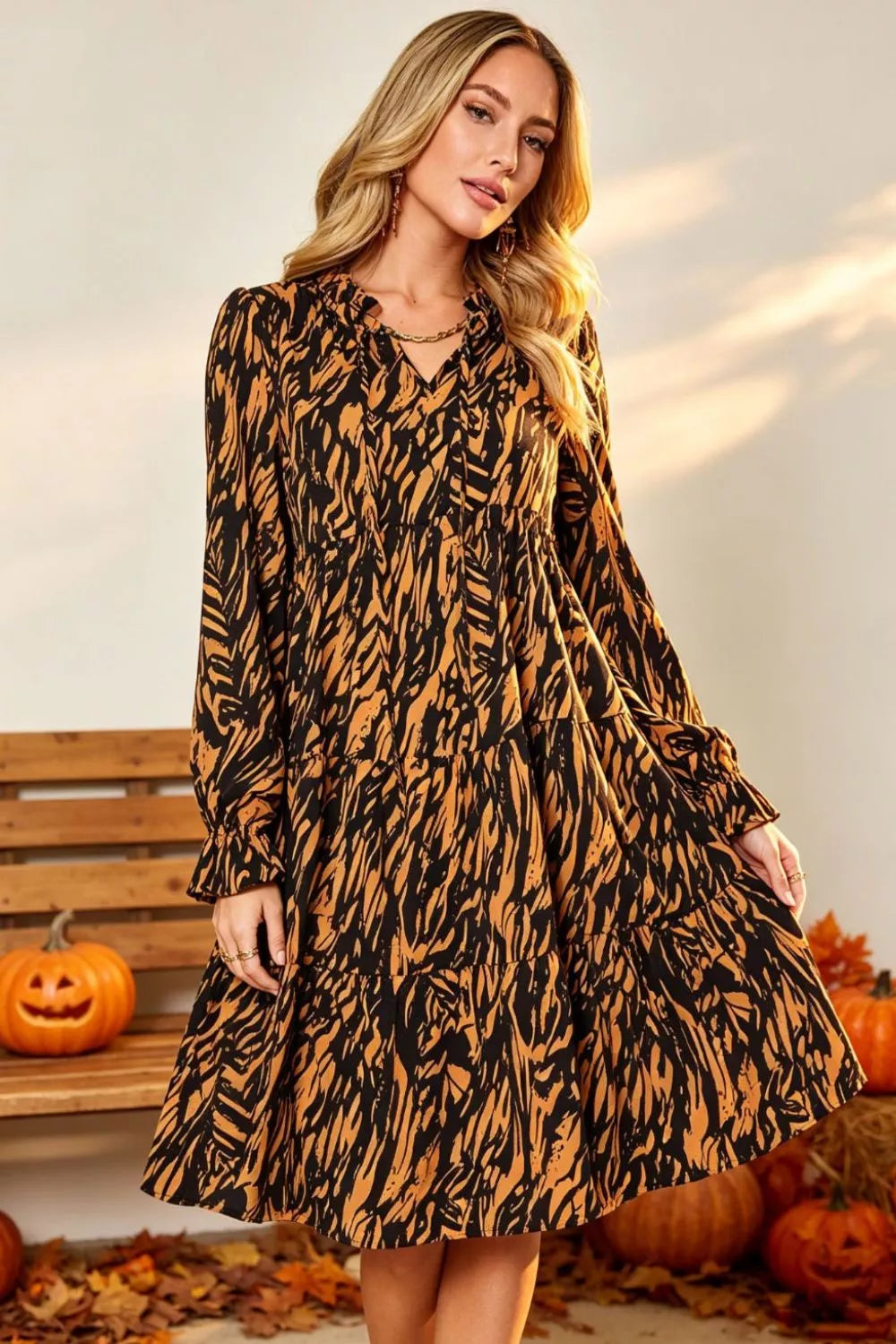 Caramel and black printed long-sleeve ruffle-hem dress with V-neck
