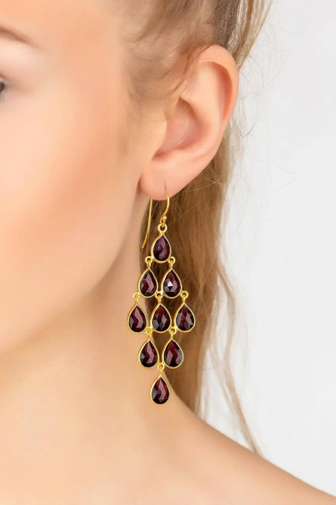 Gold-tone drop earrings with red garnet teardrop gemstones