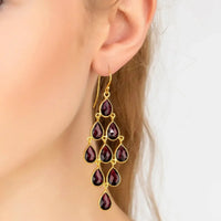 Gold-tone drop earrings with red garnet teardrop gemstones