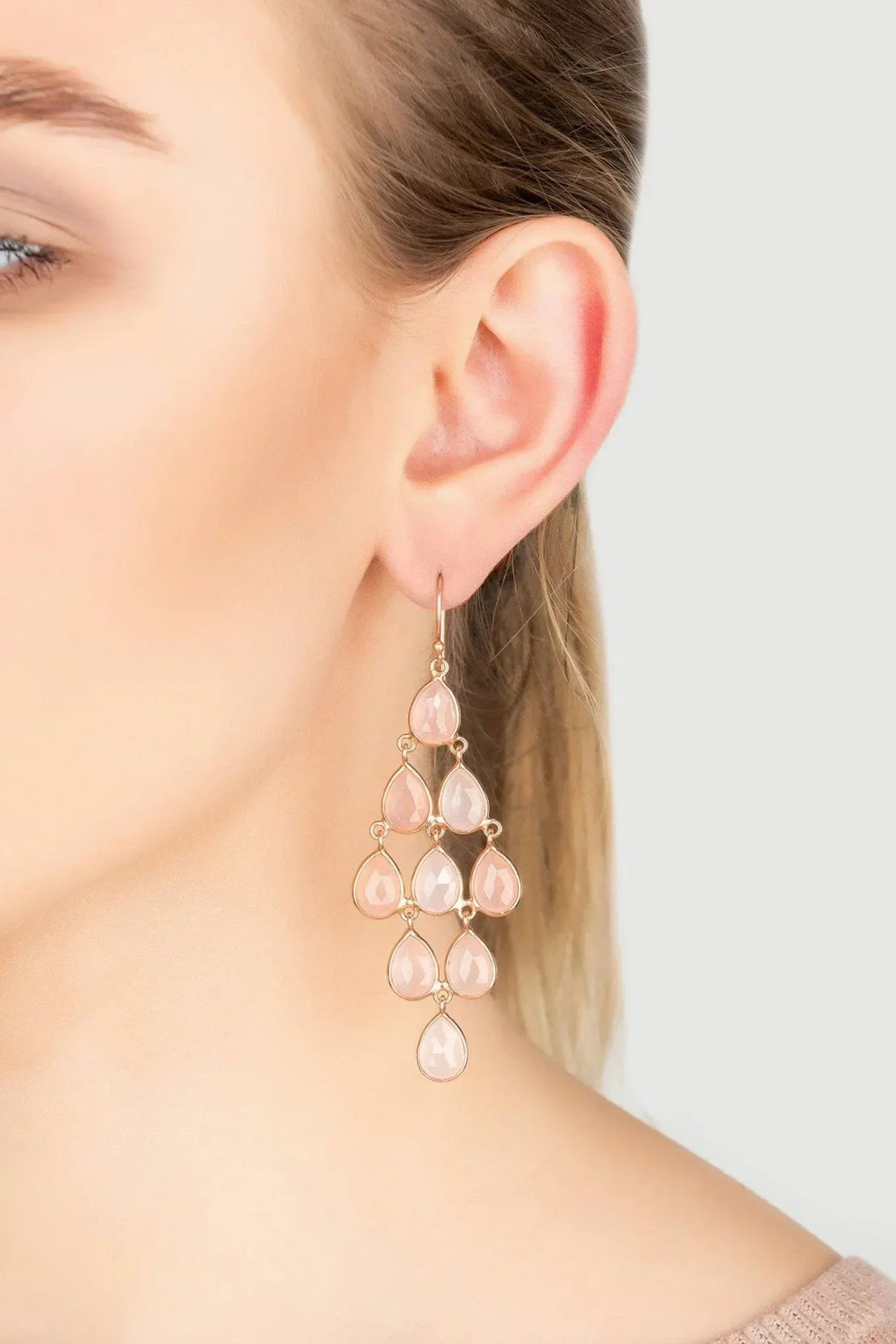Rose quartz teardrop cascade earrings, rose gold tone, worn on ear