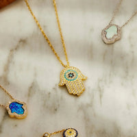 Gold evil eye charm bracelet with round blue eye bead
