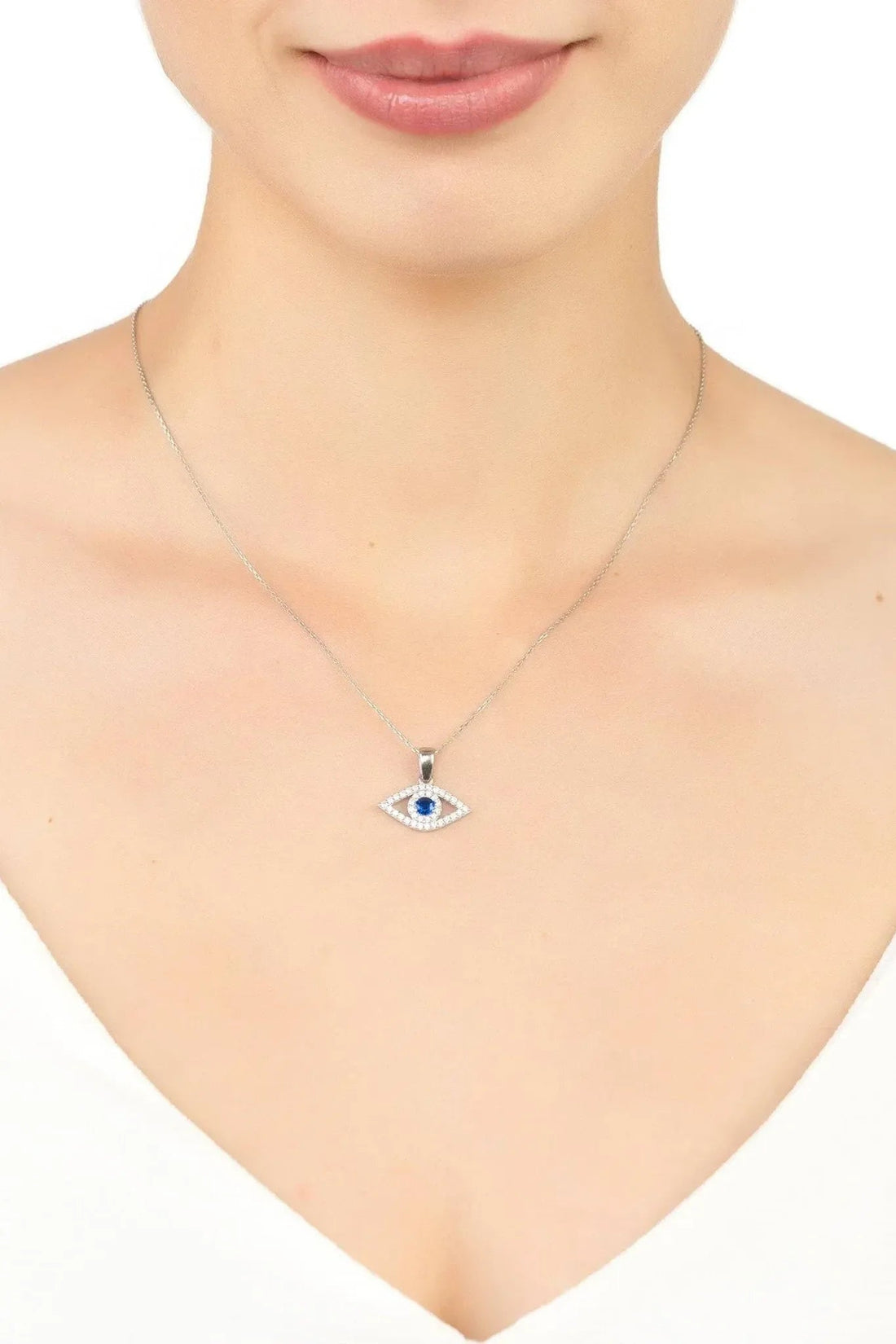 Silver evil-eye pendant necklace with blue center stone on chain.