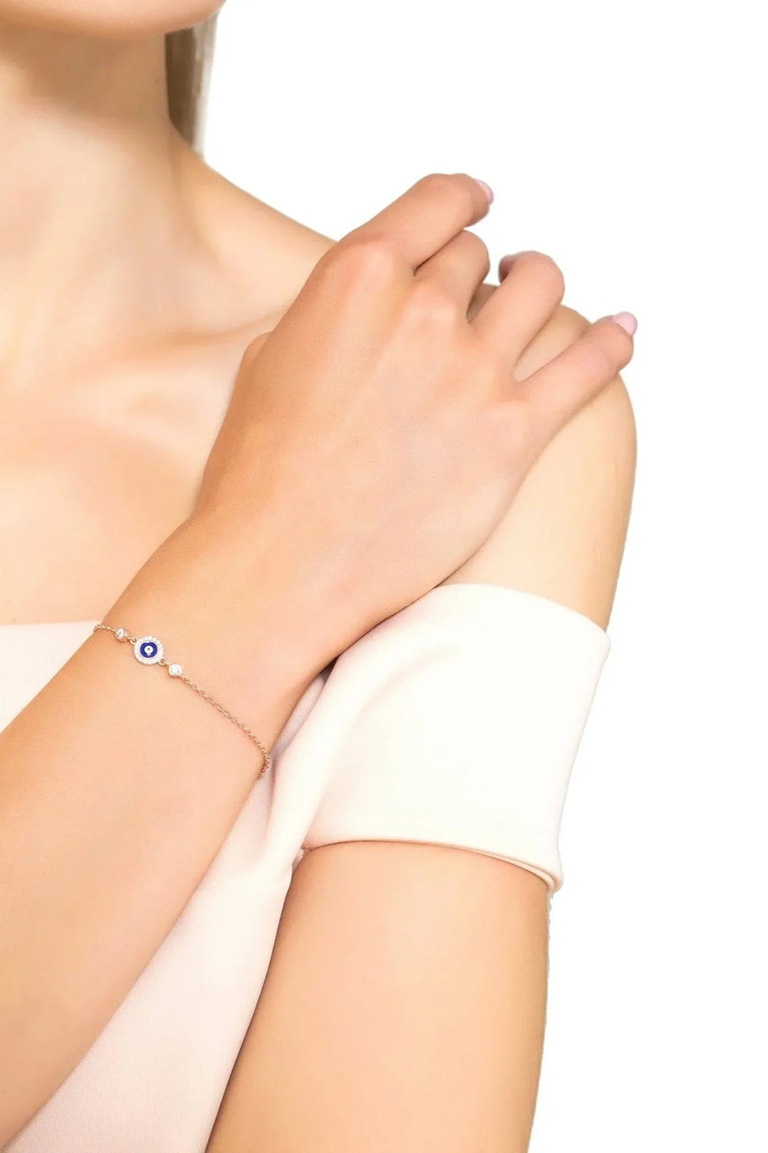 Silver evil eye enamel bracelet with dark blue eye charm on wrist