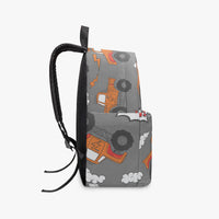 Grey monster truck backpack side view with orange truck print, black pull cord zipper pull