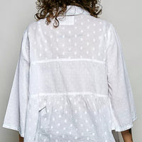 Off-white button-front shirt with tonal dot pattern, back view