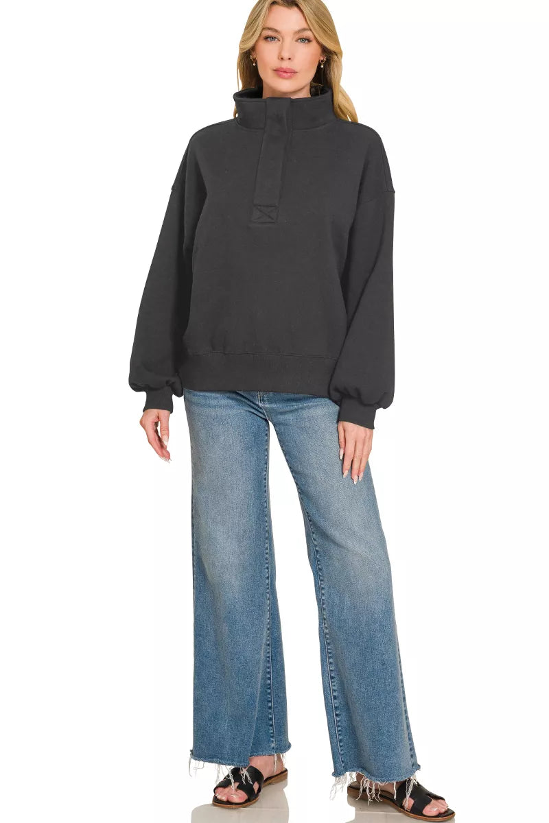 Black fleece half-snap sweatshirt with stand collar and long puff sleeves