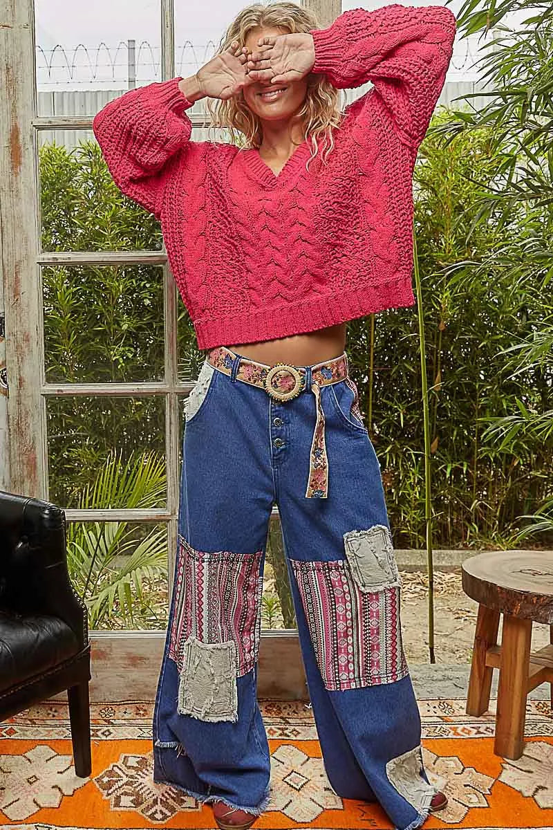 Fuchsia cable-knit cropped V-neck sweater, long balloon sleeves, textured stitch pattern