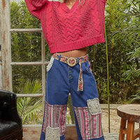 Fuchsia cable-knit cropped V-neck sweater, long balloon sleeves, textured stitch pattern