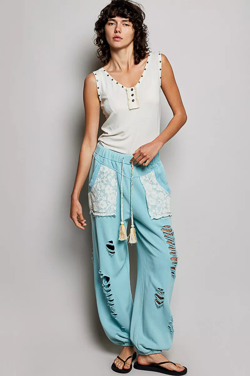 Cream button-front ruffle tank with studded neckline and decorative button placket