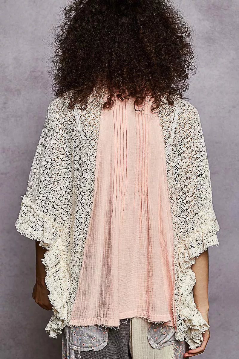 Women’s back view of baby pink pleated shirt with lace crochet patch sleeves