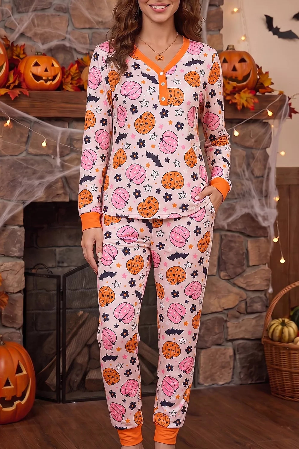 Dusty pink pumpkin-print long-sleeve pajama set with orange-trim pockets and pants cuffs