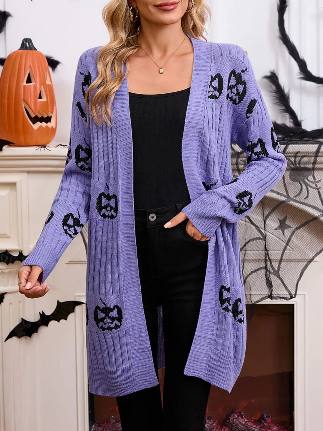 Purple open-front knit cardigan with black jack-o-lantern pattern, draped front