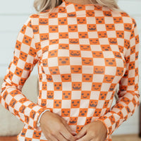 Halloween long sleeve mock neck blouse with orange-and-white checker print and jack-o’-lantern faces