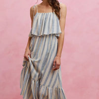 Sleeveless striped tiered midi dress with tie shoulder straps and blue-and-white vertical stripes
