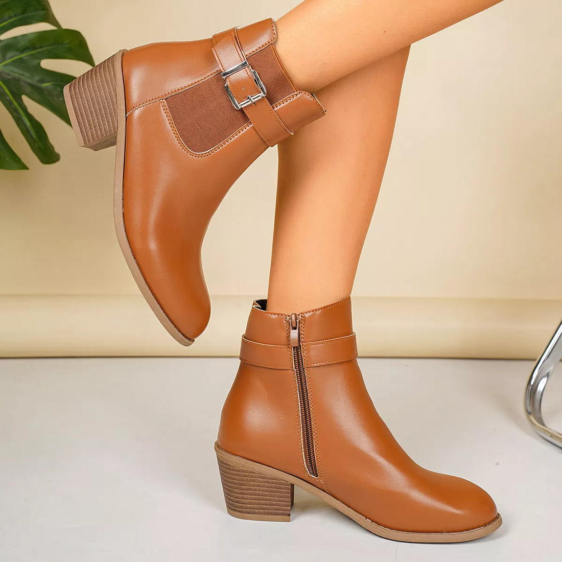 Point-toe block heel boots in tan/brown with side zip and buckle strap detail