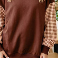 Dark brown loose tunic sweatshirt with plaid check long sleeves and ribbed cuffs