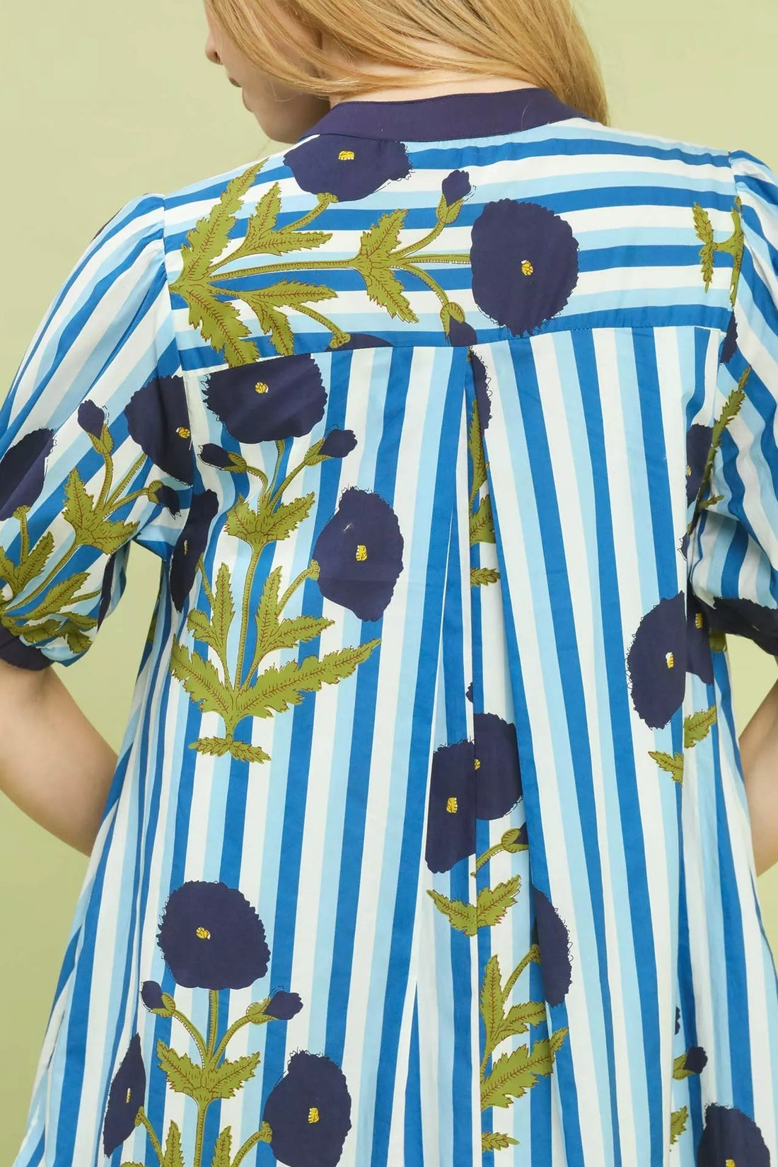 Close-up of blue striped dress back with floral print and navy edging