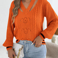 Orange cutout cable knit sweater with V-neck, cable texture, and knit lotus motifs
