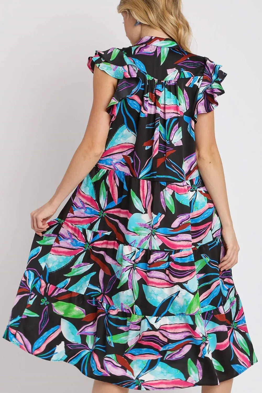 Plus size midi dress back view with ruffled sleeves and tiered skirt, leaf print.