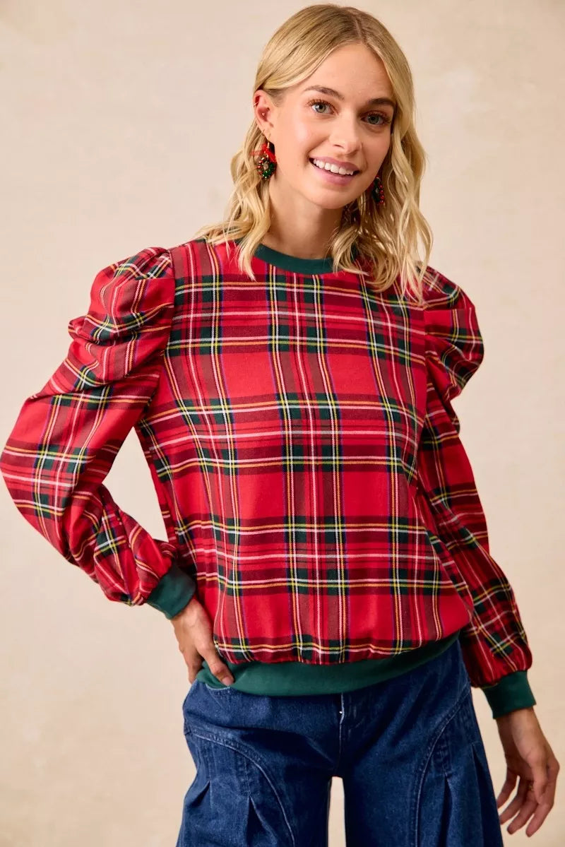 Red plaid top with exaggerated shoulders, balloon sleeves, and green ribbed waistband
