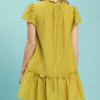Back view of Avocado textured mini dress with ruffled cap sleeves and tiered hem