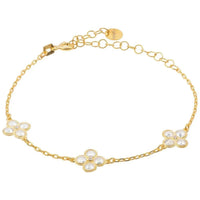 Gold bracelet with three clover charms and clear crystal stones on a link chain