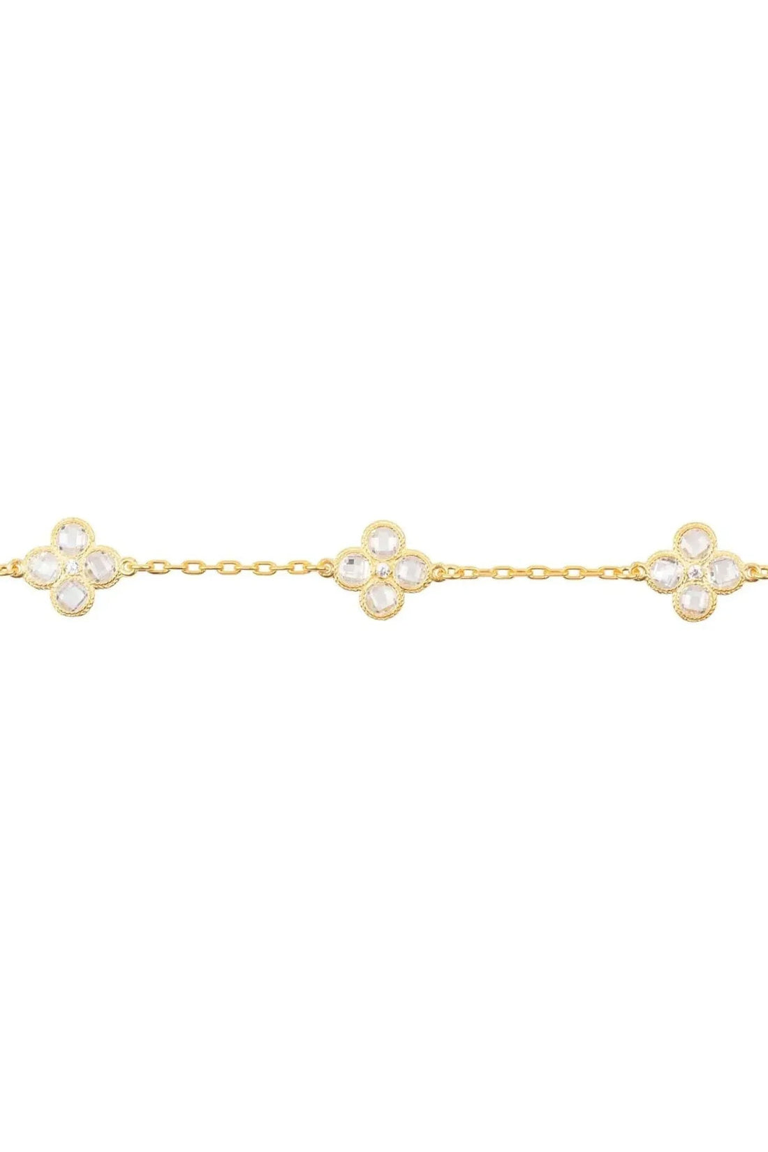 Gold link bracelet featuring three clover-shaped crystal flower charms