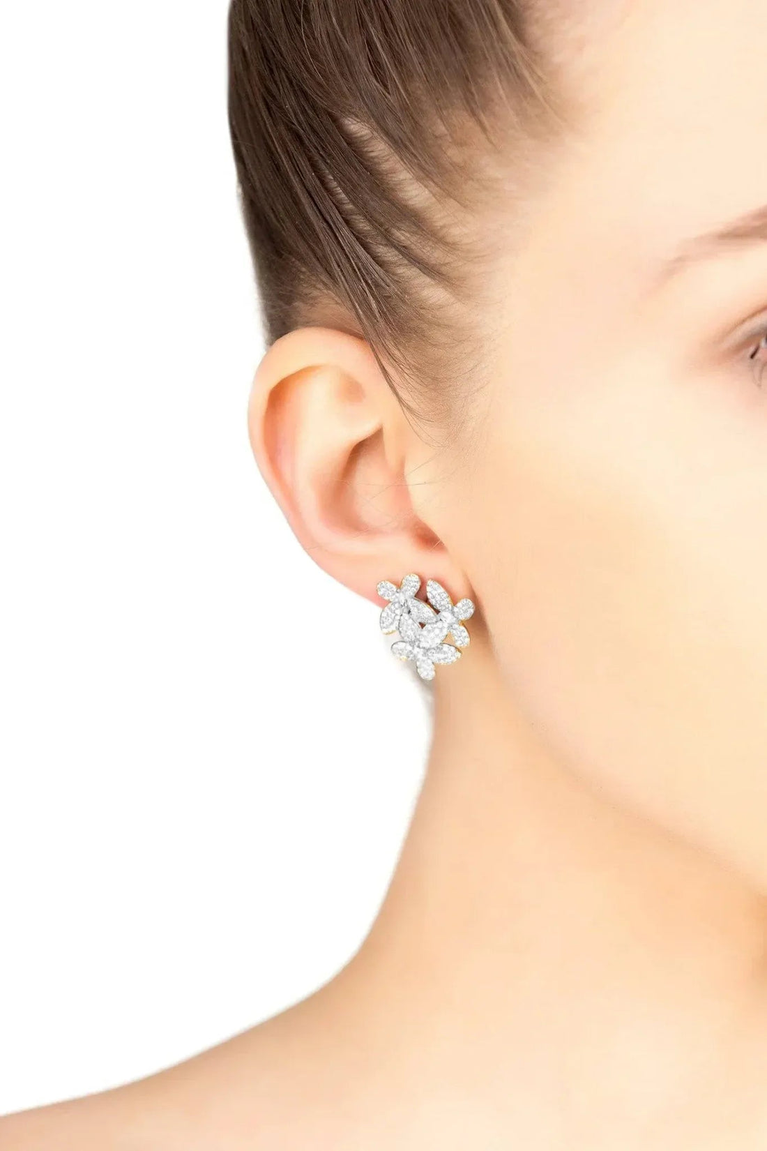 Large silver flower stud earrings worn on ear