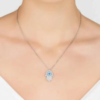 Hamsa evil eye pendant necklace on neckline, silver chain with turquoise eye
