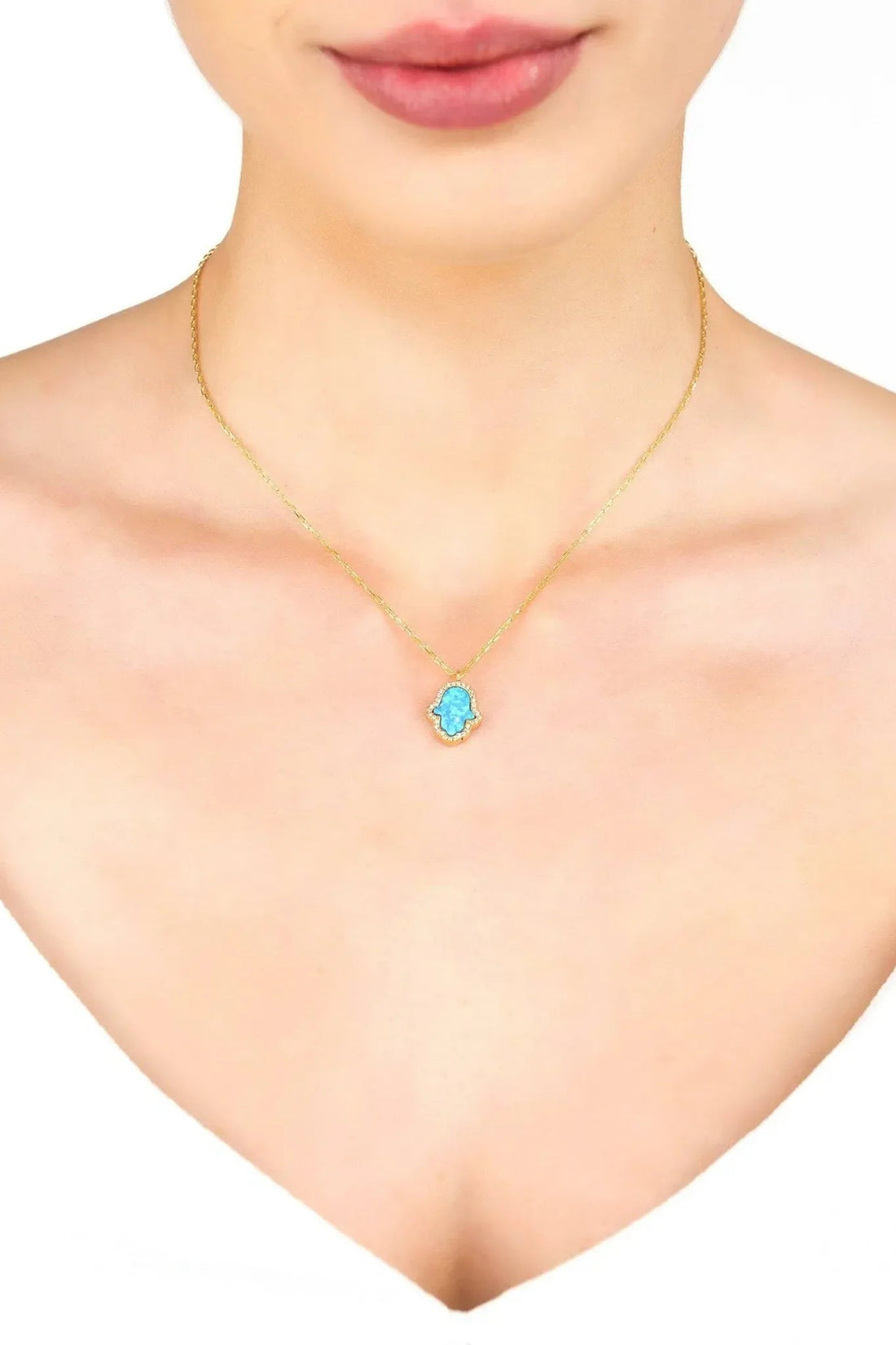 Gold-tone Hamsa opalite blue pendant necklace on neckline