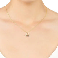 Gold heart pendant necklace with small heart charm at the center